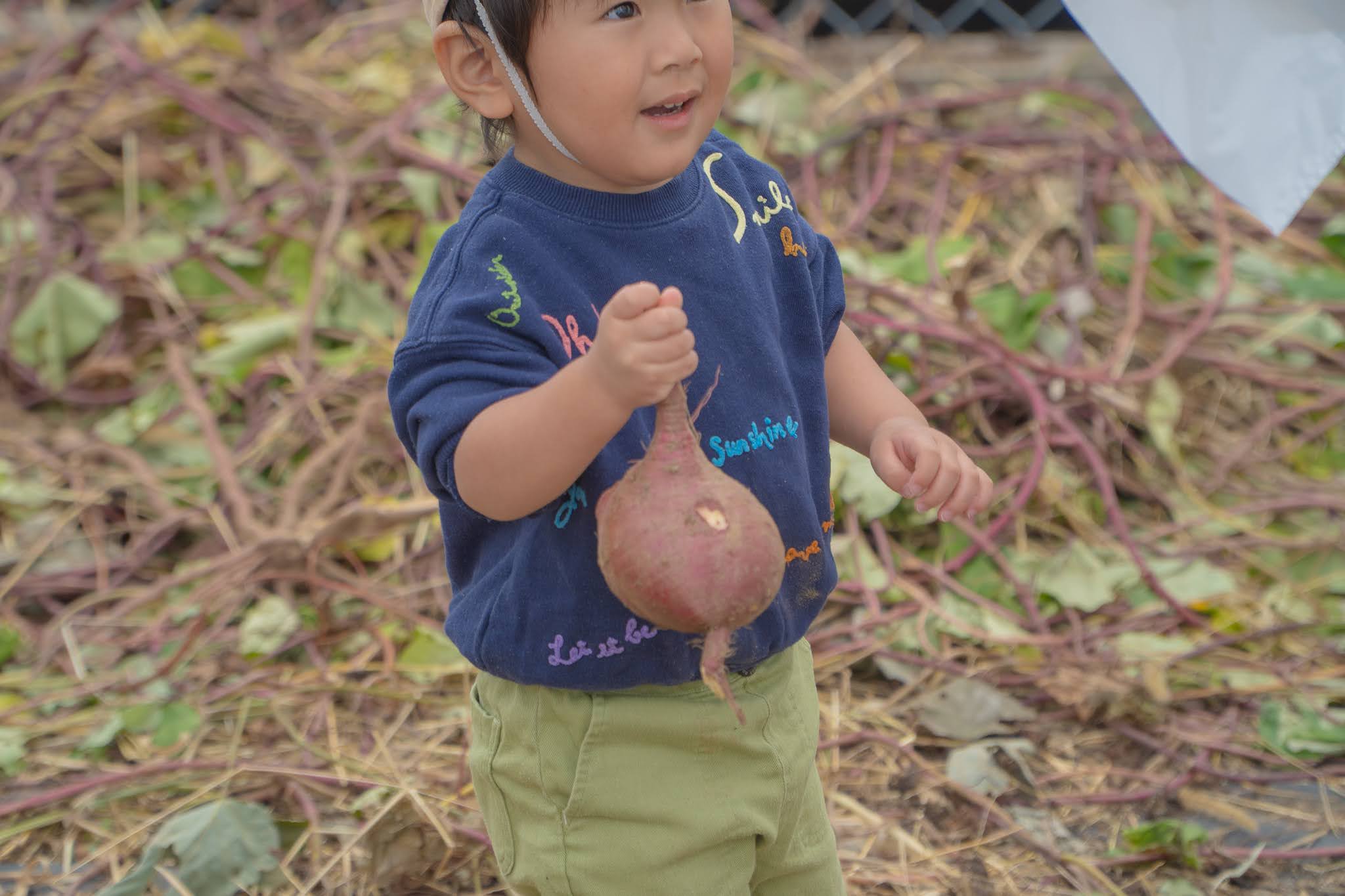 お芋を手に嬉しそうな子