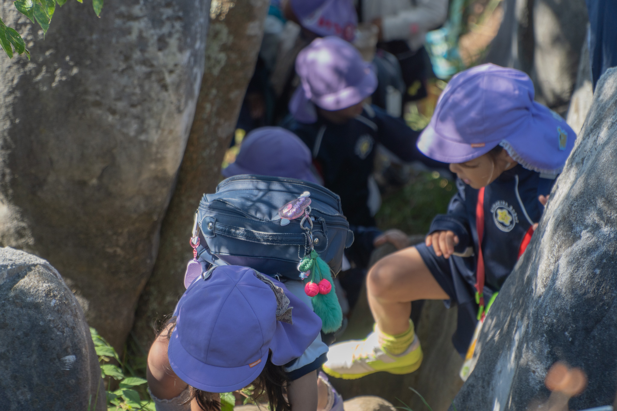 岩陰をのぞく子ども